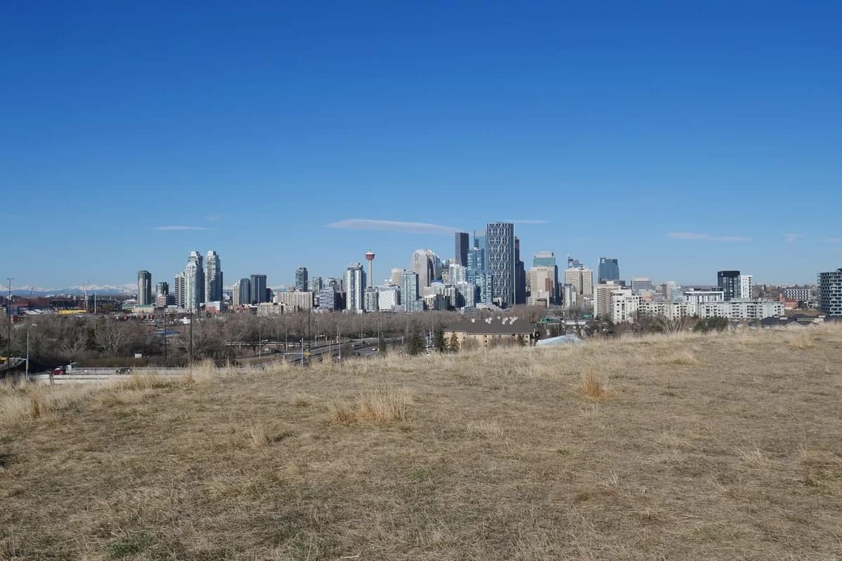Calgary skyline seen across open grassland