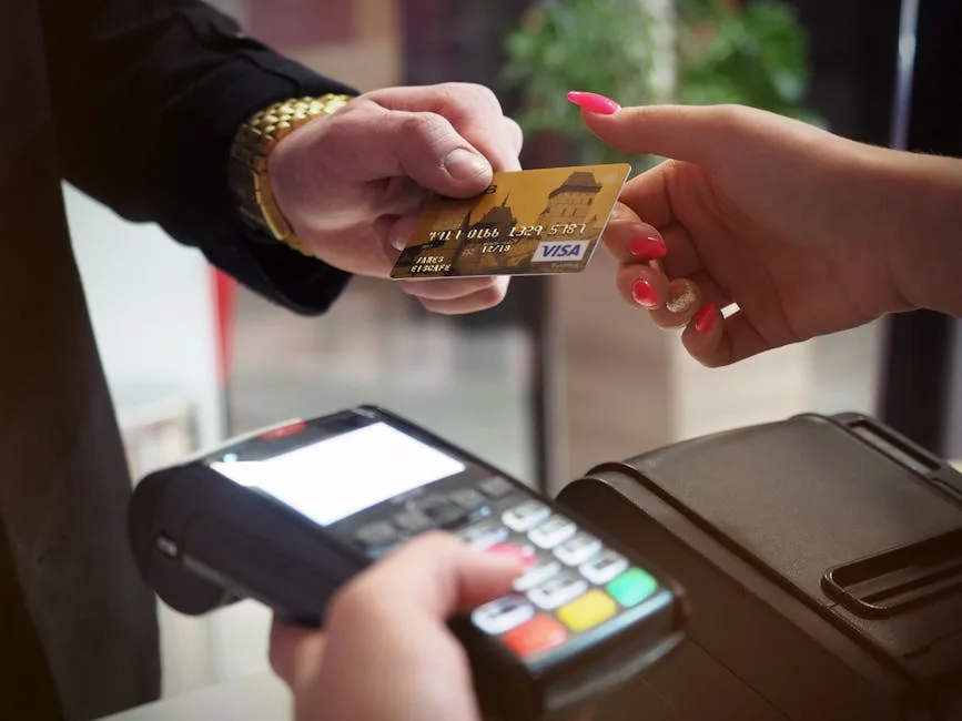 Customer paying by card at a checkout terminal, where GST is collected on the sale