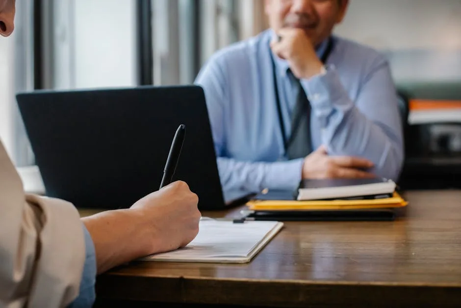 Accountant and business owner reviewing financial documents together