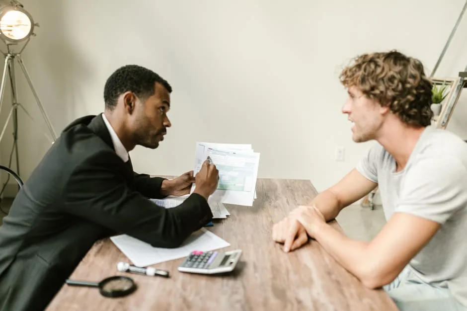 Calgary CPA reviewing Notice of Objection documents with a client at a desk